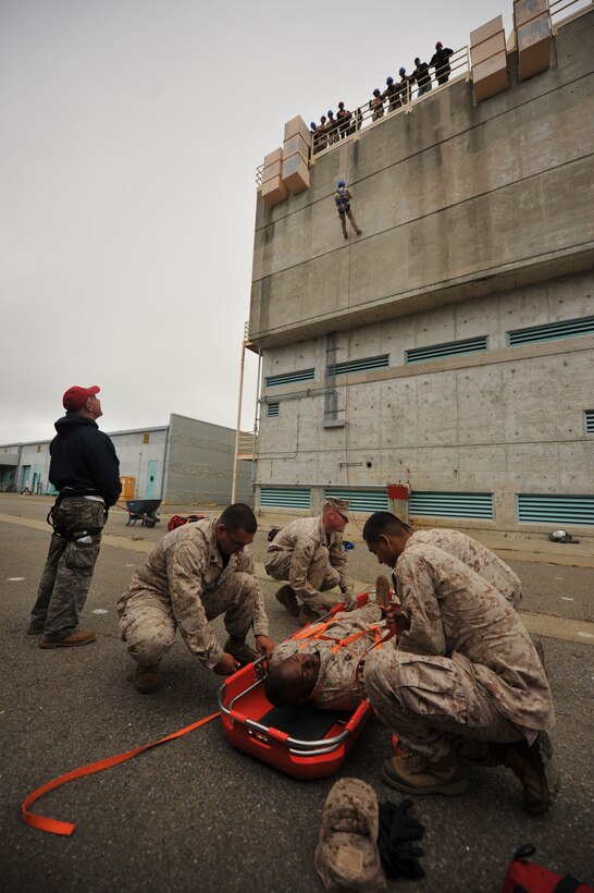 Marines with Combat Logistics Battalion 11, the logistics combat element for the 11th Marine Expeditionary Unit, practice securing people to Stokes baskets during high-angle rescue training with Northern California Rescue Training at the San Francisco Fire Fighter School here July 12.